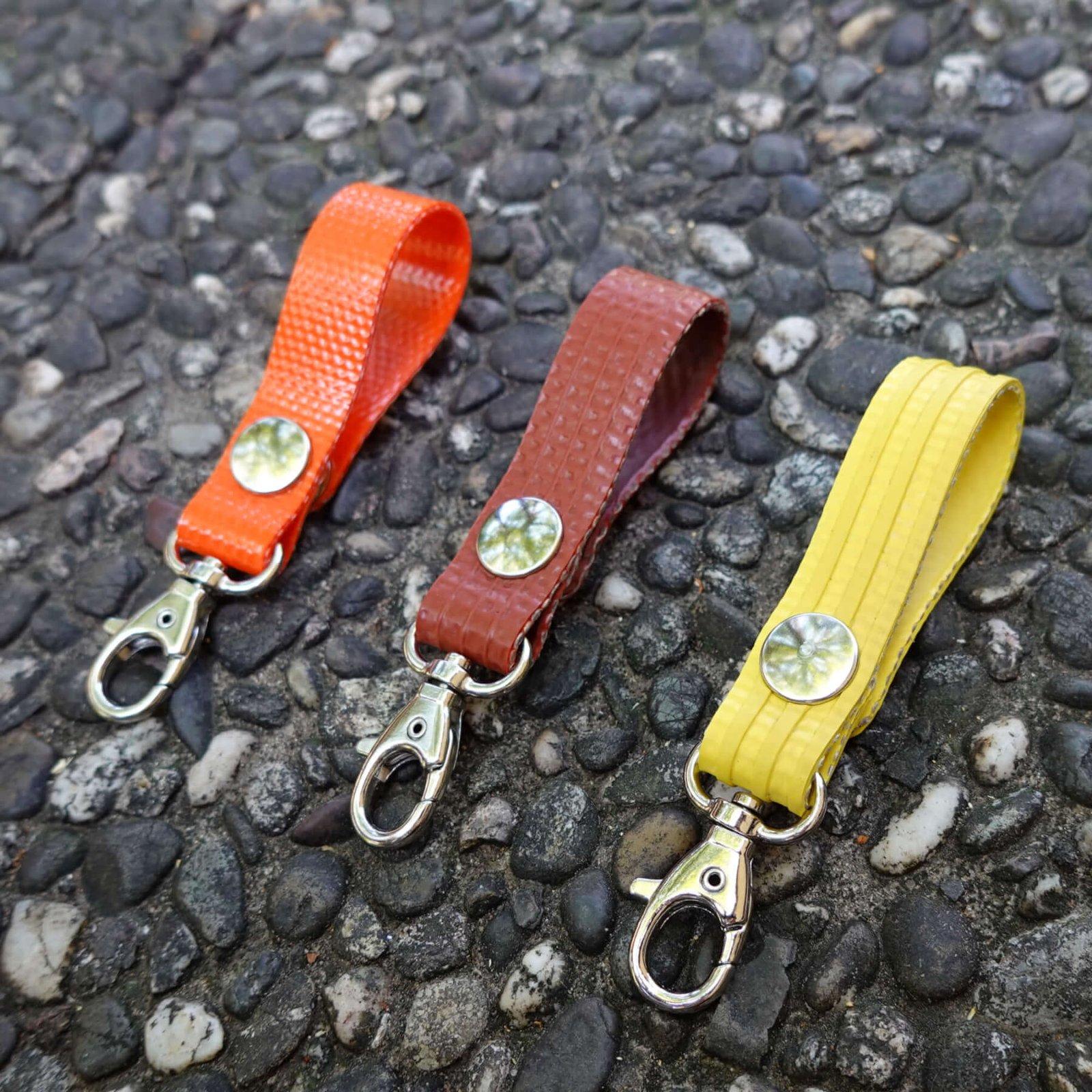 Porte-clés en tuyaux de lances à incendie upcyclées. Couleur au choix : rouge, orange ou jaune. Fermeture par aimant